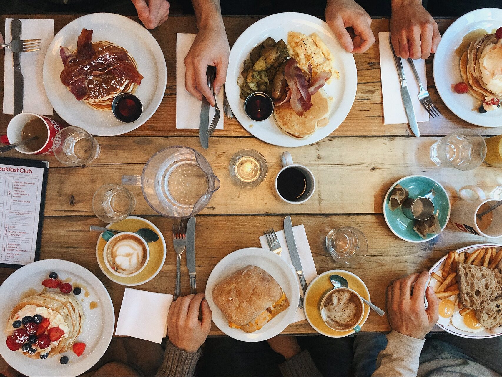 assorted variety of breakfast foods on plates on dining table