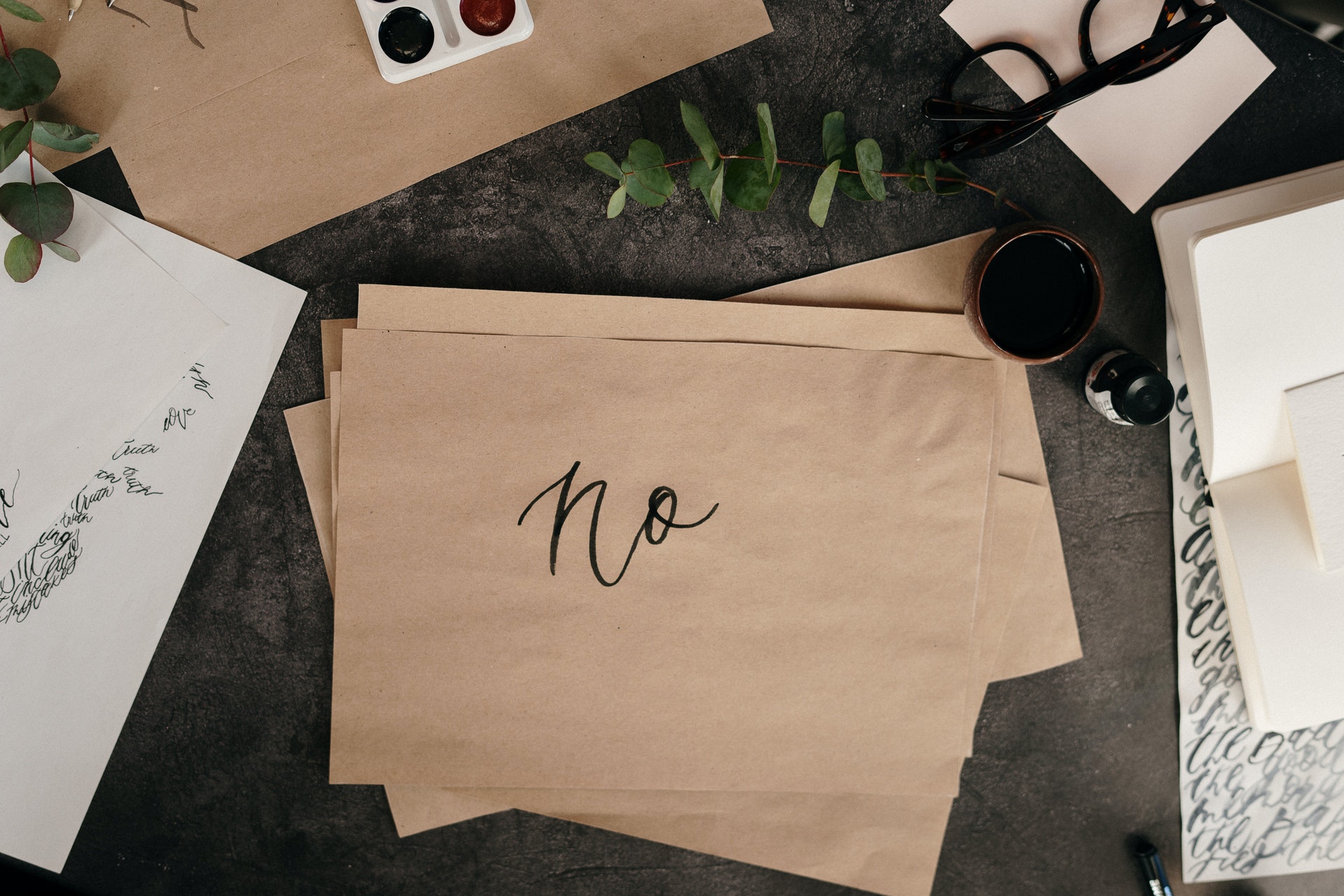 Flat brown paper bag on black desk saying no