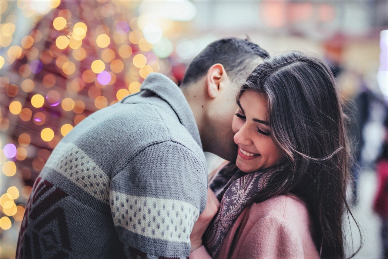 Middle Eastern man kissing right cheek of Middle Easter woman, expressing her love language.