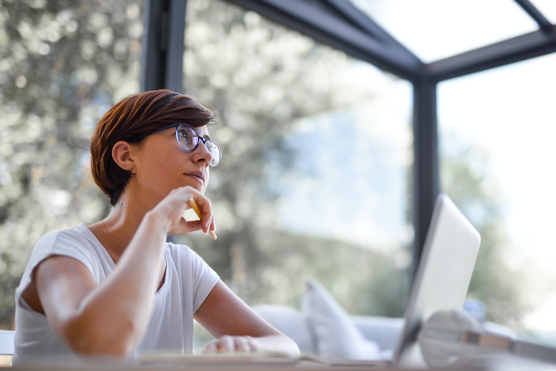 White woman with pixie cut red hair contemplating her identity