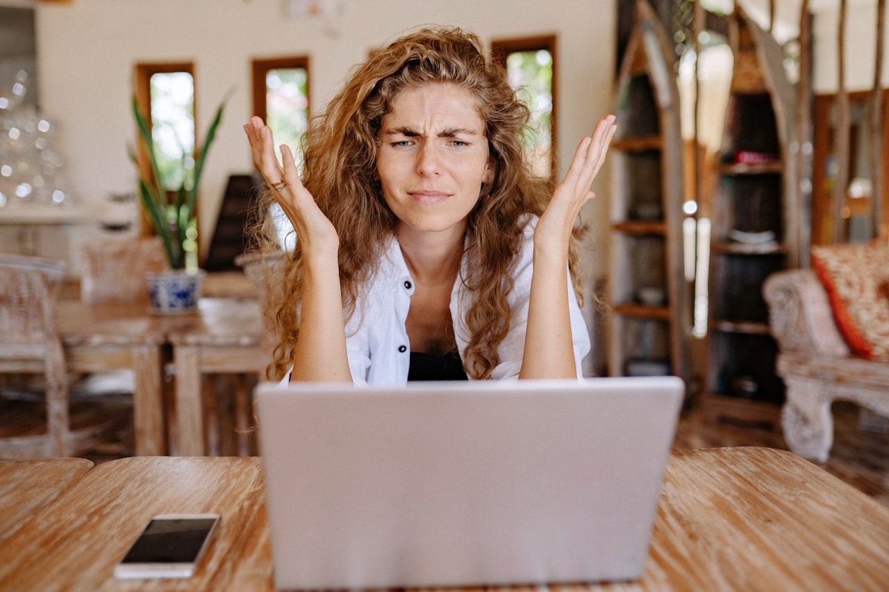 Young White woman looking at laptop not being patient and frustrated